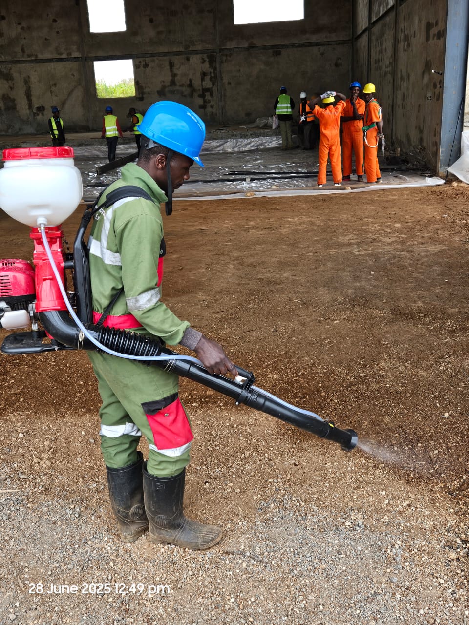 Worker spraying foundation